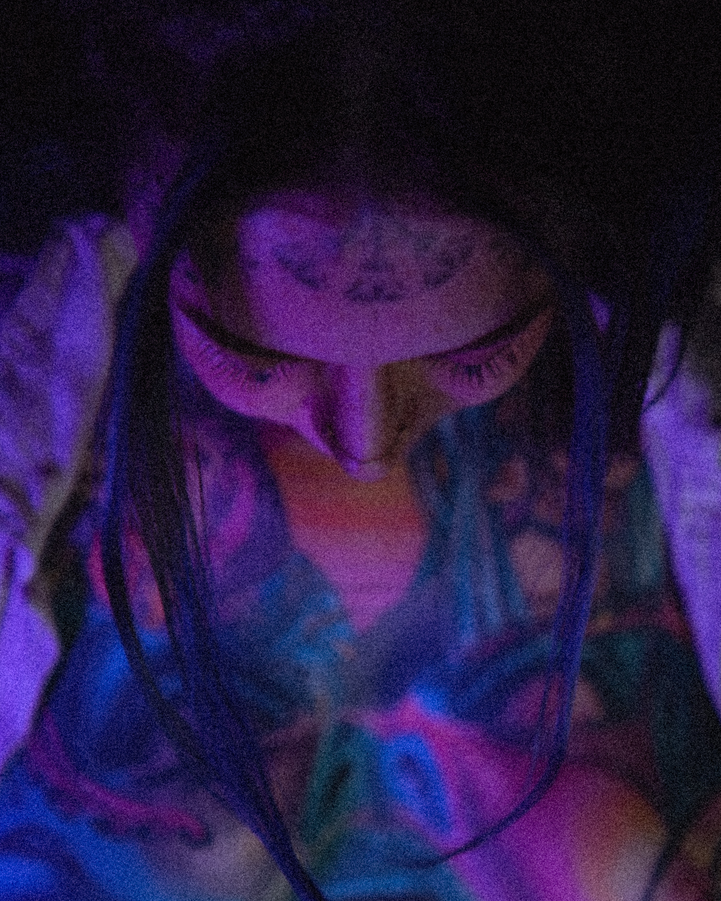 Muse reference photograph by Samma Charles — abstract close-up portrait under layered purple, blue and red light